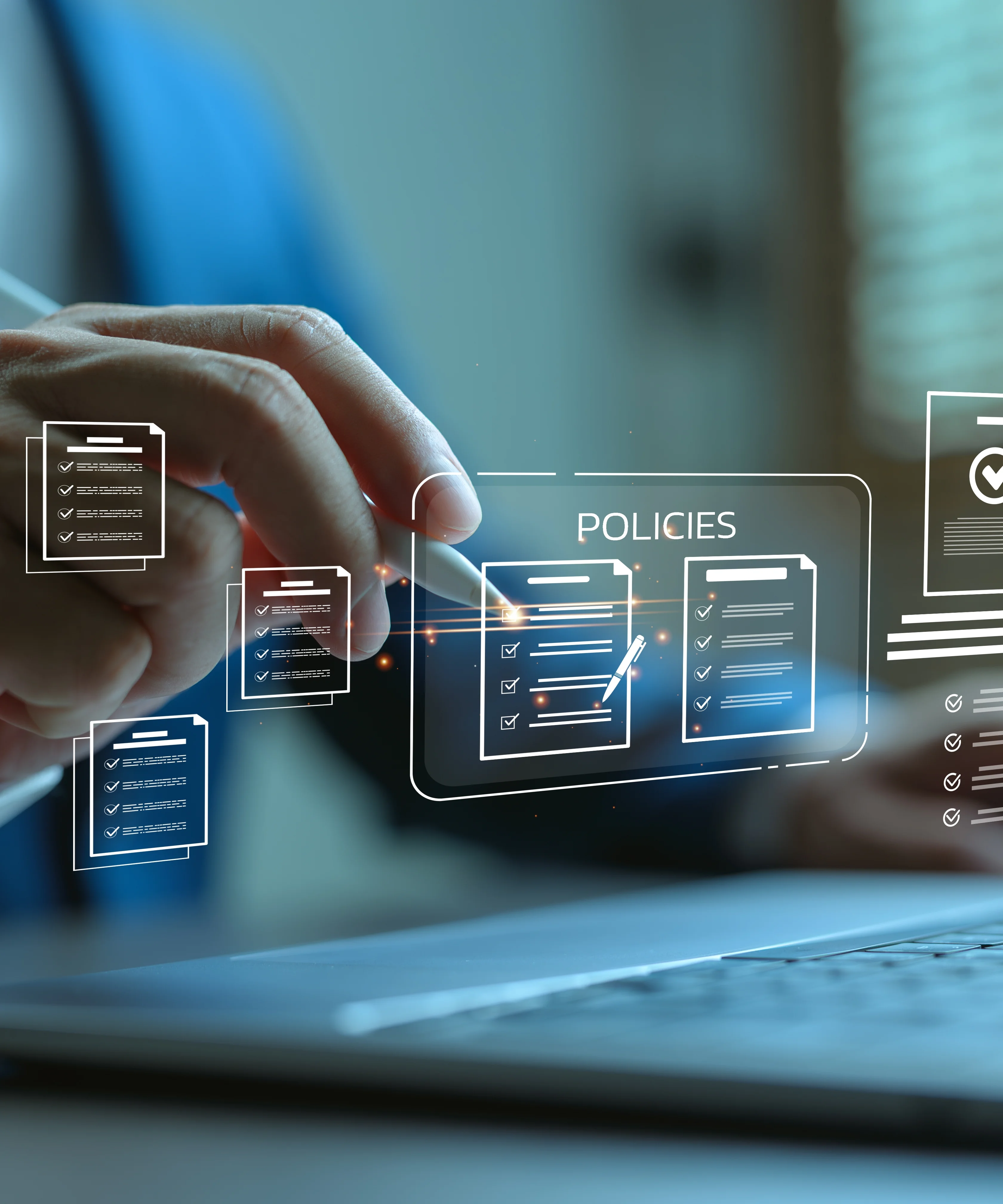 A cropped image of a person in front of a laptop, showing only the person's hands. There are line icons representing policy documents floating over the keyboard. The person is interacting with the icons with a stylus.